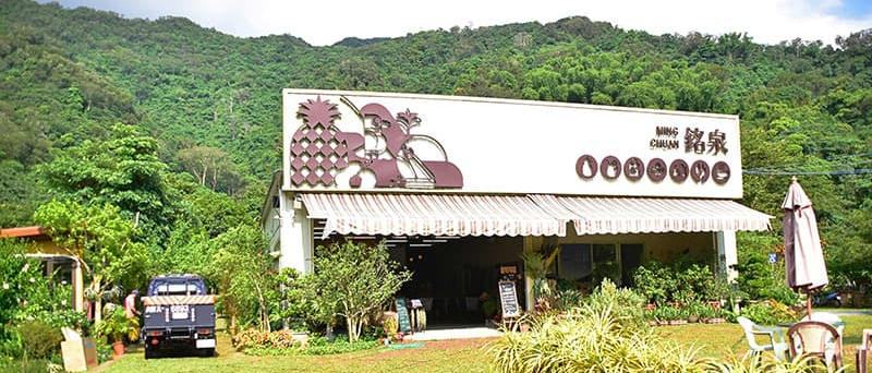 佳義村銘泉生態休閒農場招牌與綠色山景